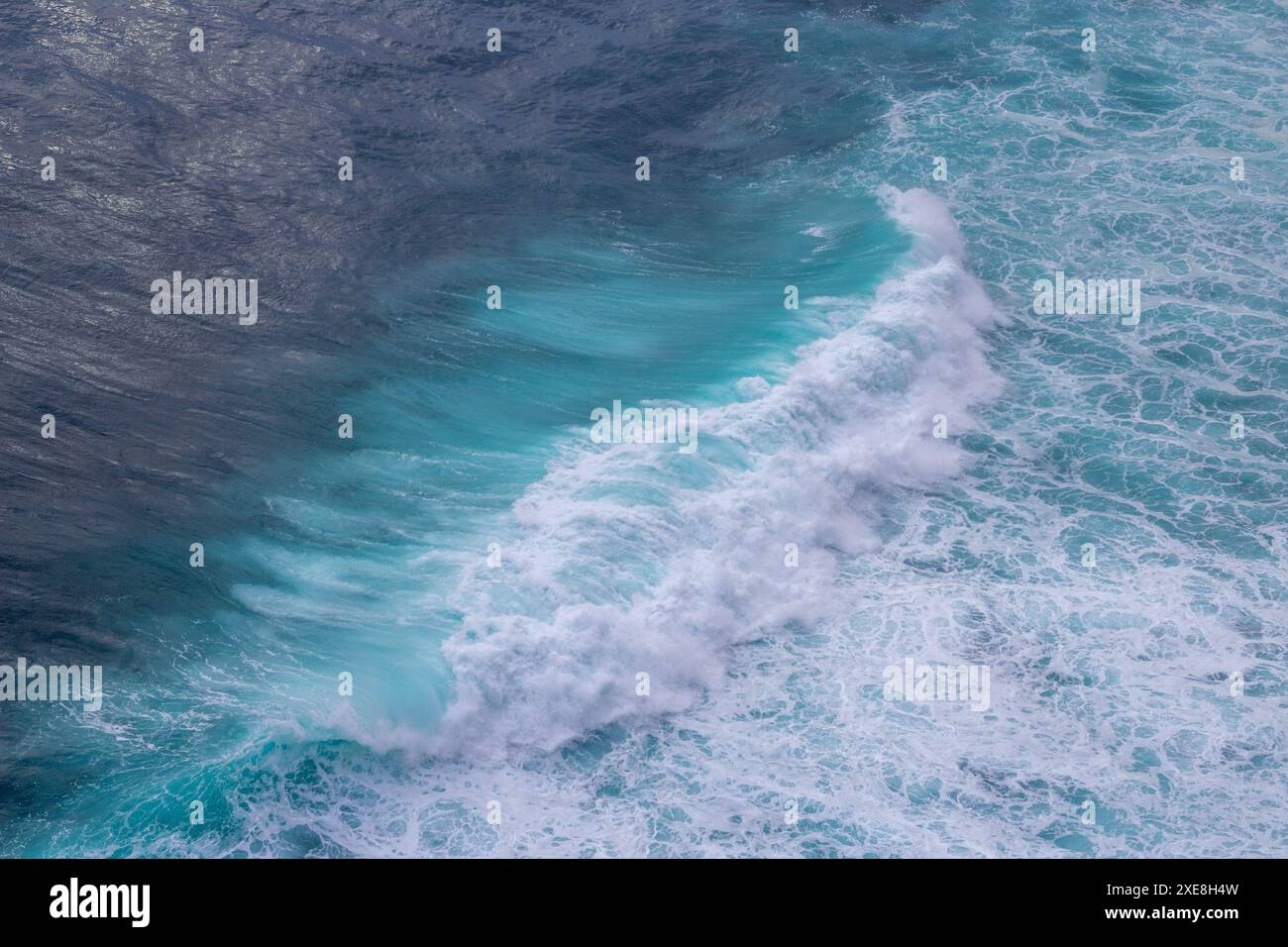 Aerial view of ocean waves with splashes and foam. Blue water ...