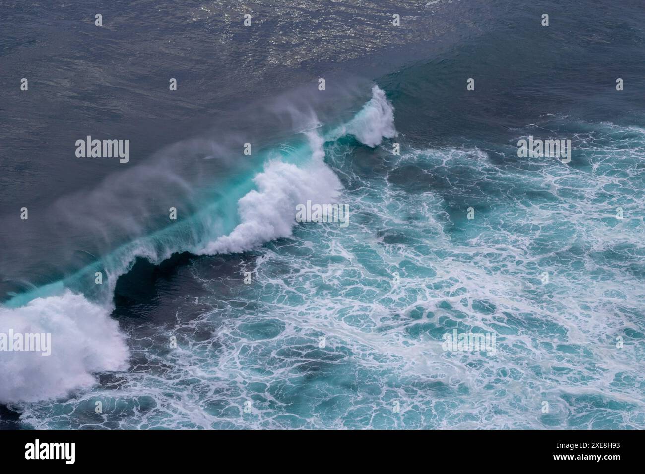 Aerial view of ocean waves with splashes and foam. Blue water ...