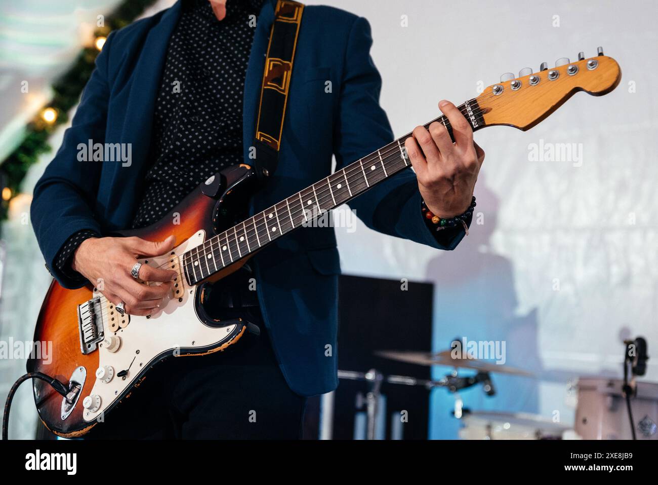 Rock band studio rehearsal. Male musician playing bass guitar before live concert Stock Photo