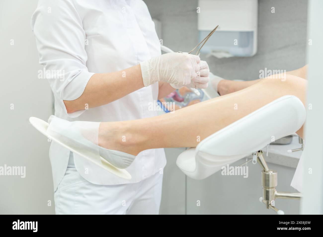 Gynecologist opening up band aid with forceps Stock Photo - Alamy
