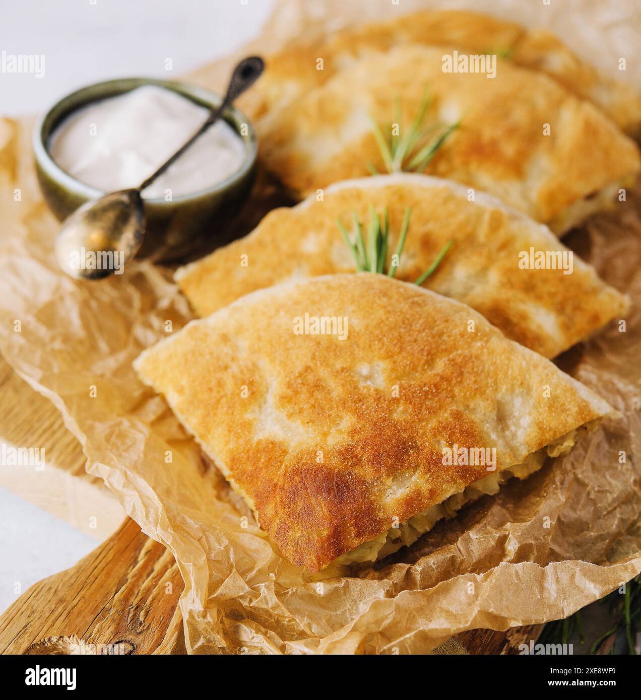 Delicious pies filo pastry with chicken, spinach and feta close-up on the table Stock Photo