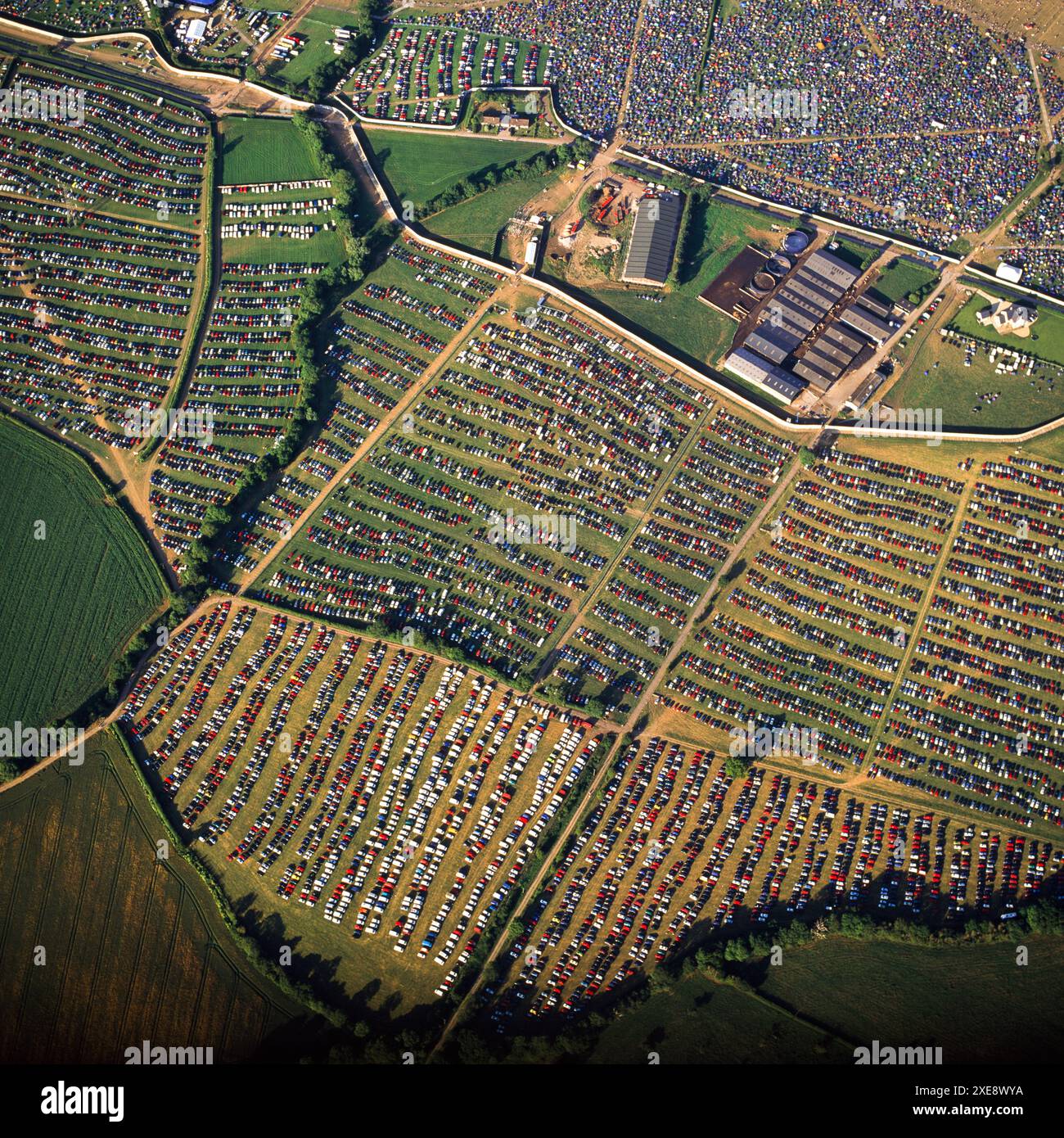Aerial Image Glastonbury Festival, showing colourful mosaic display of cars, Sat 28th June 2003, Pilton, near Glastonbury, England, UK Stock Photo