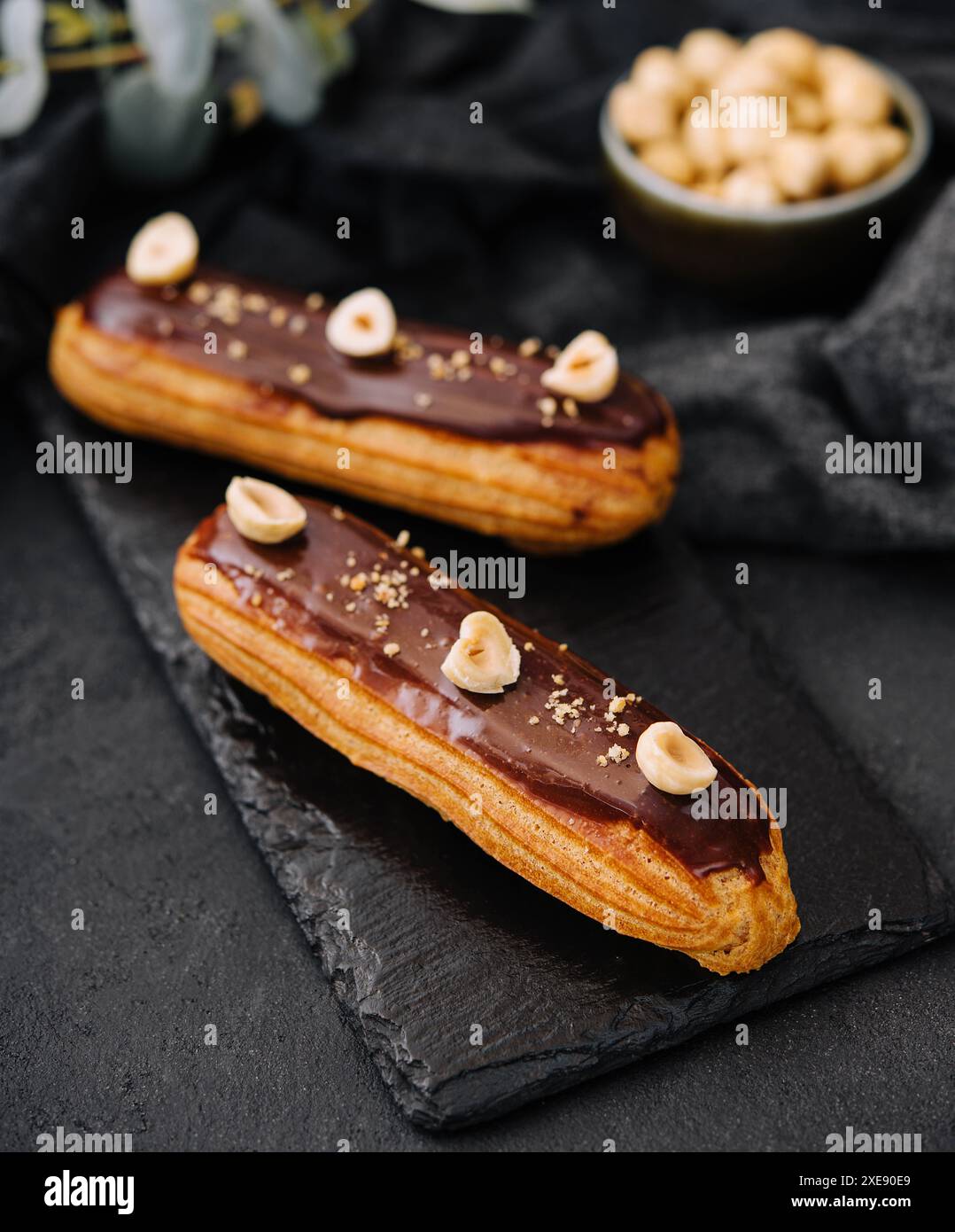 French eclairs with chocolate and hazelnuts Stock Photo
