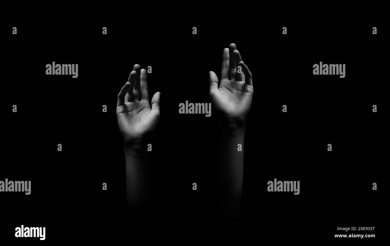 Two Hands Reaching Upward in a Dark Background Stock Photo