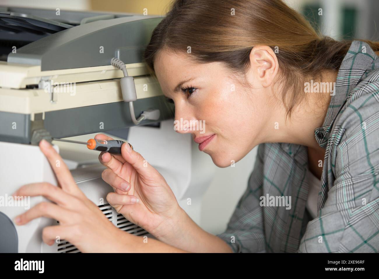 woman is fixing a printer Stock Photo