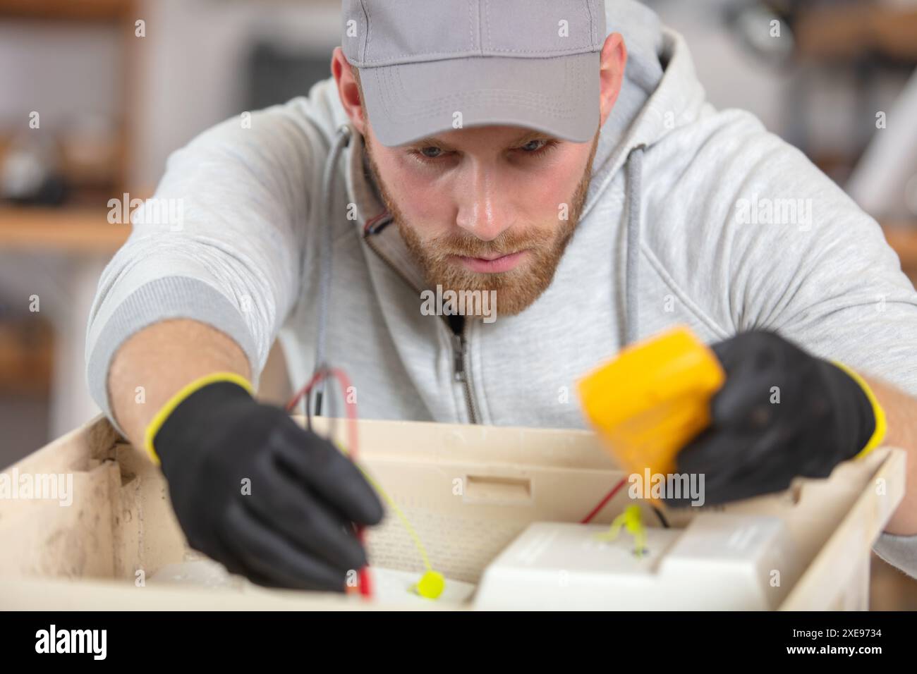 electrician installing energy saving meter Stock Photo