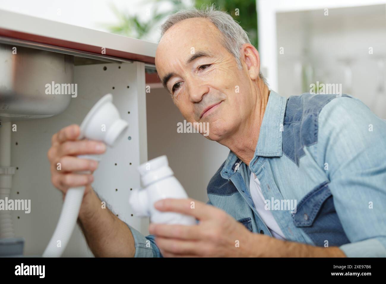 man fixing pipes at home Stock Photo