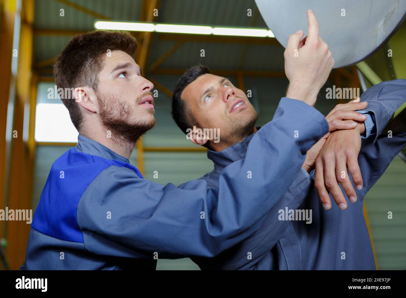 portrait of two engineers gesturing together Stock Photo