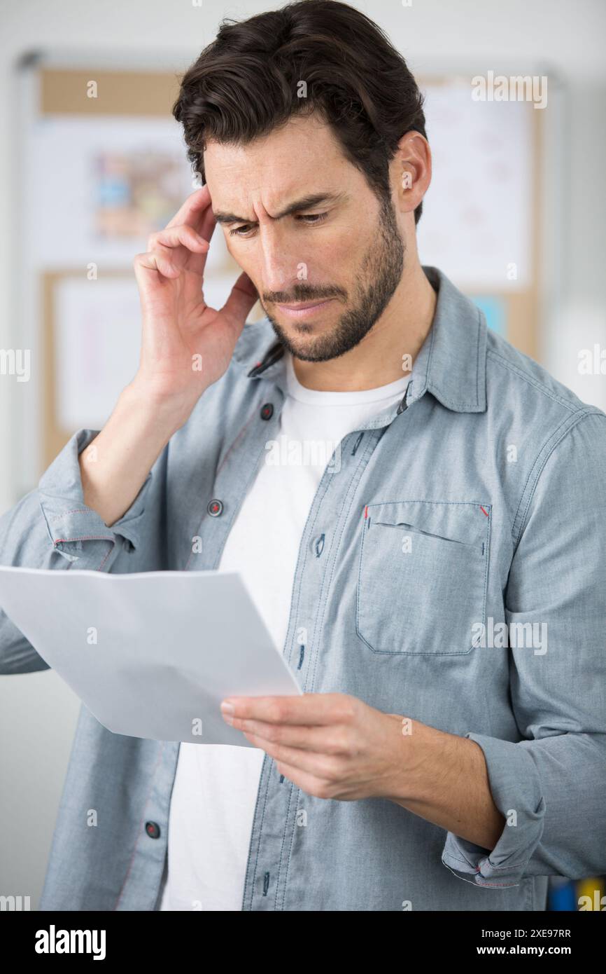 Serious creative man reading documents hi-res stock photography and ...