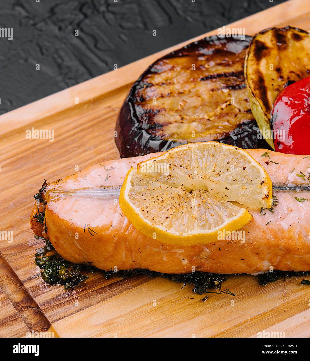 Salmon steak on the grill with grilled vegetables Stock Photo - Alamy
