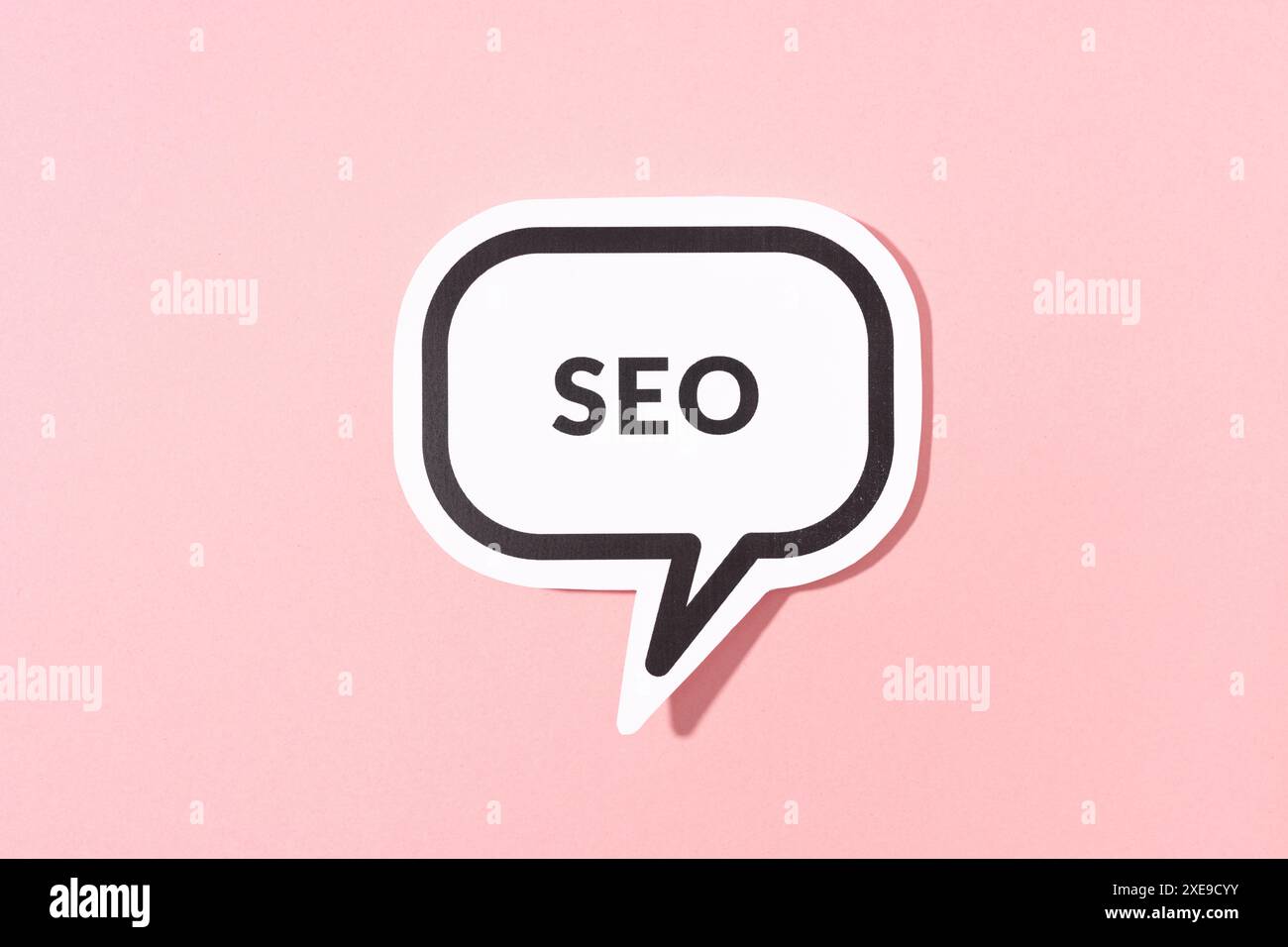 SEO text on speech bubble isolated on pink background Stock Photo