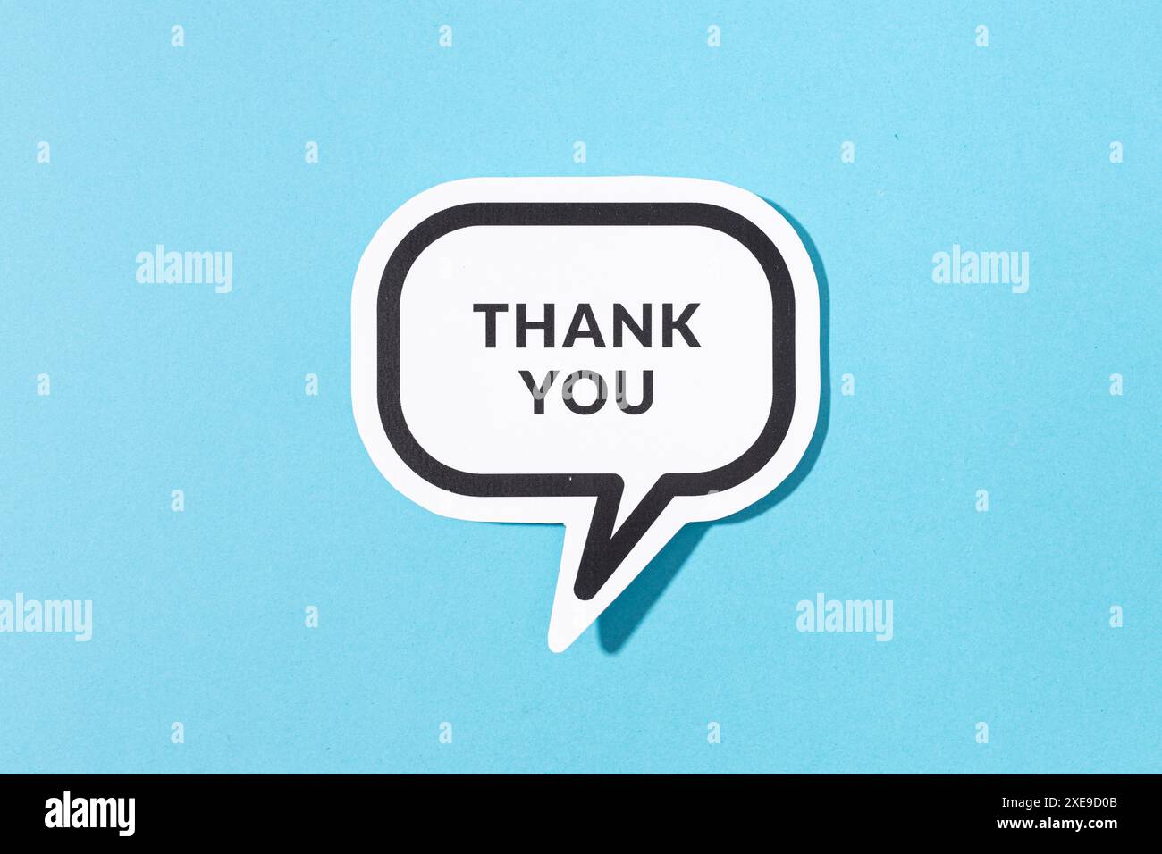Thank you text on speech bubble isolated on blue background Stock Photo