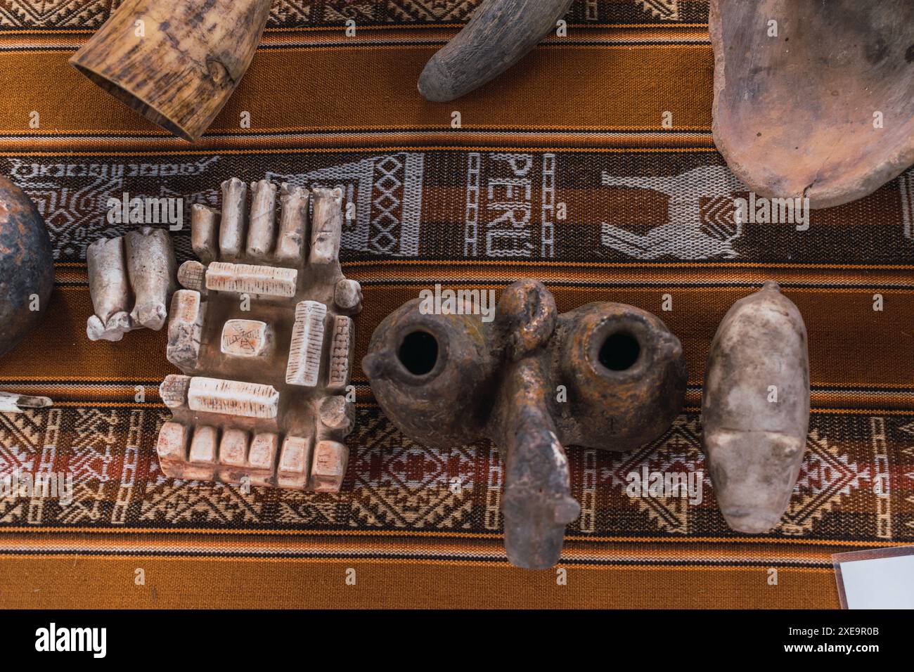 Inca Plate ceramics in the incas on a traditional table with traditional blanket ...