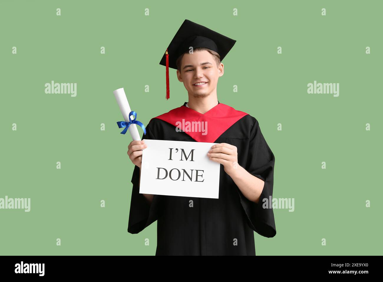 Happy male graduate holding diploma and paper sheet with text I'M DONE ...