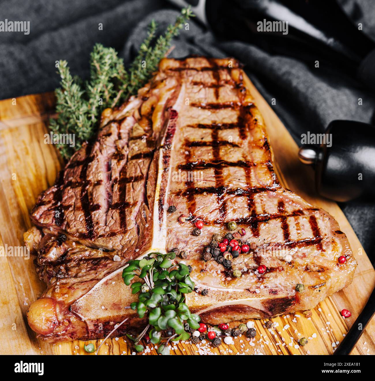 A big grilled steak on a wooden plate Stock Photo