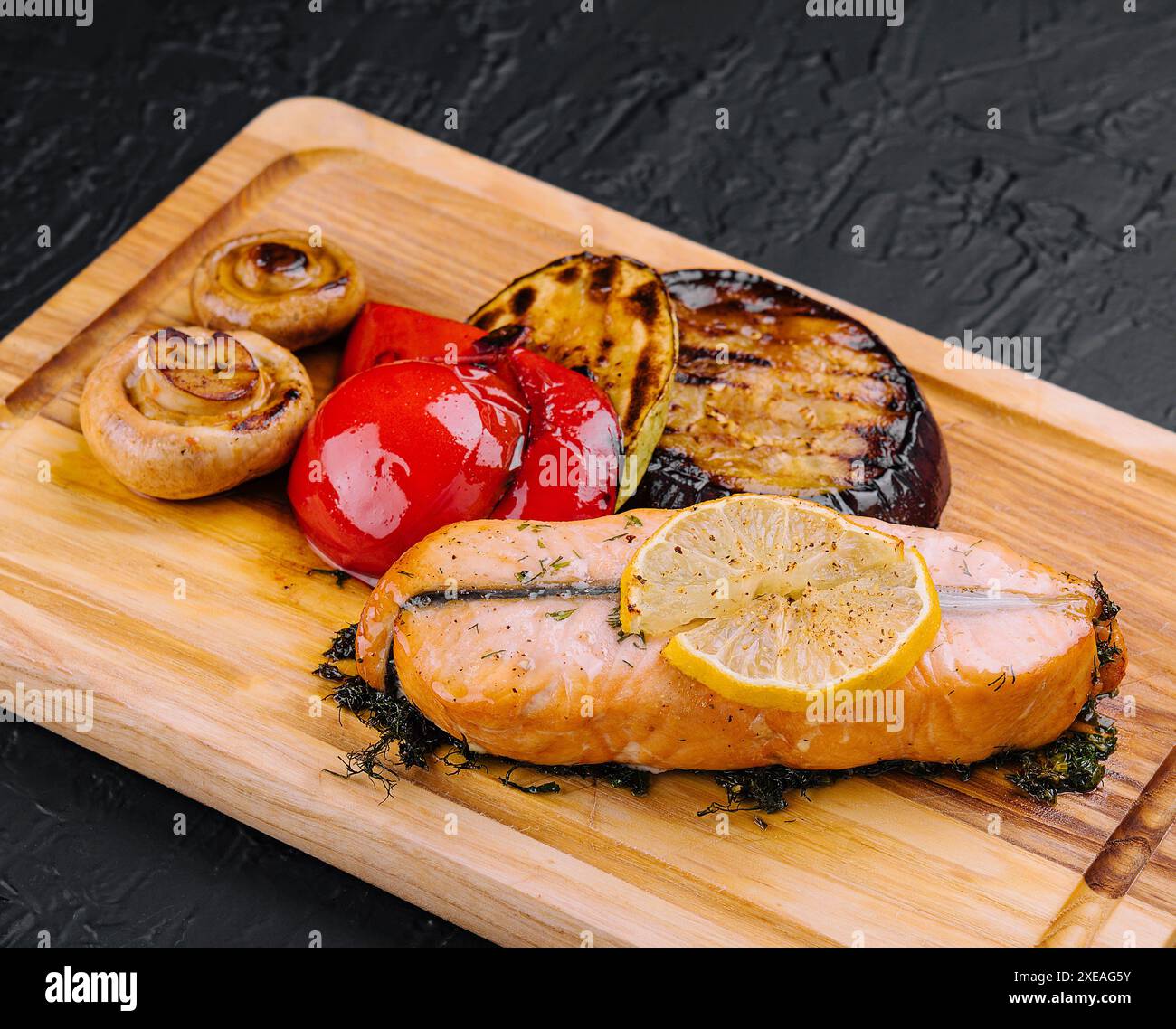 Salmon steak on the grill with grilled vegetables Stock Photo - Alamy