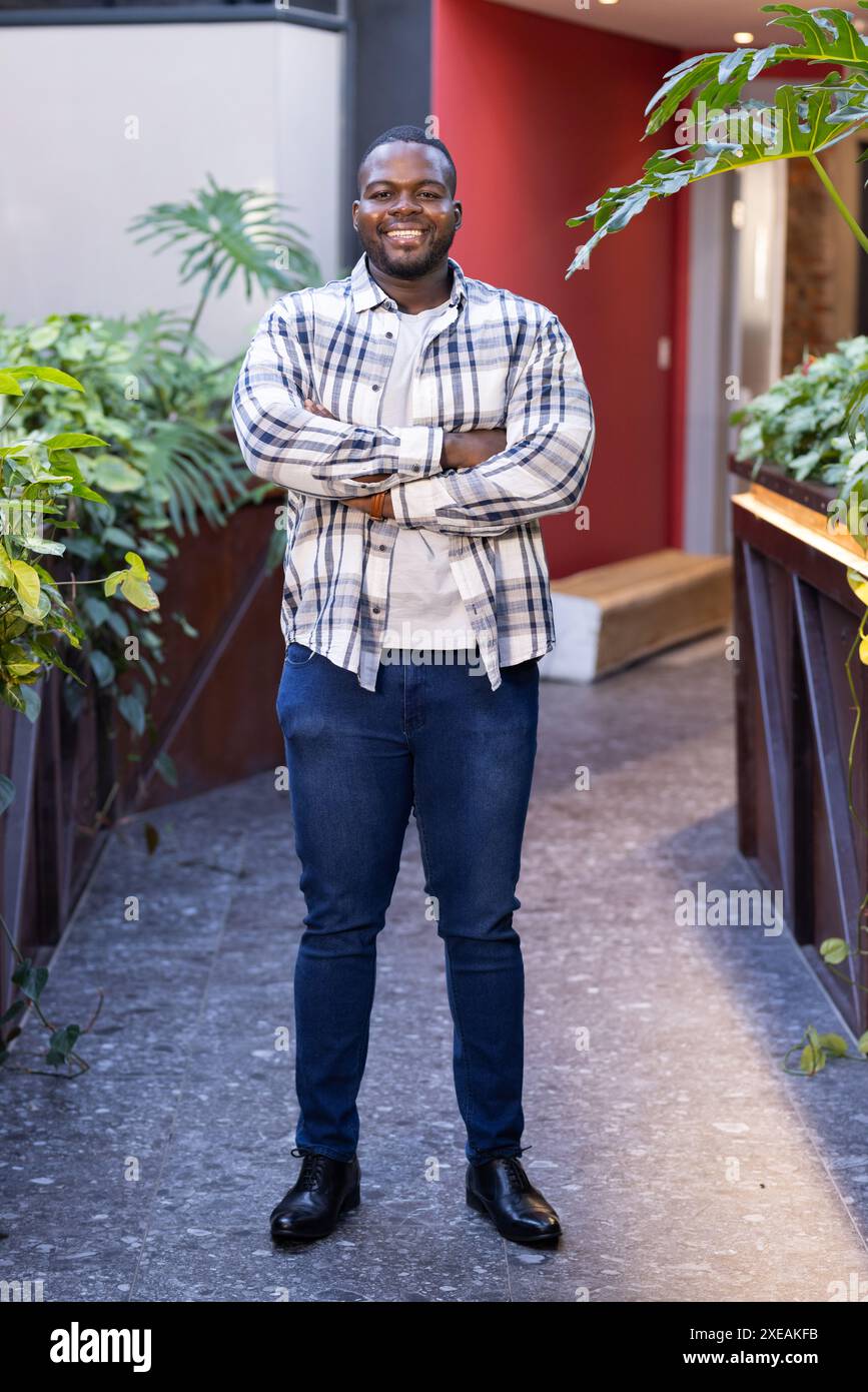 Smiling African American man standing confidently in casual business attire Stock Photo