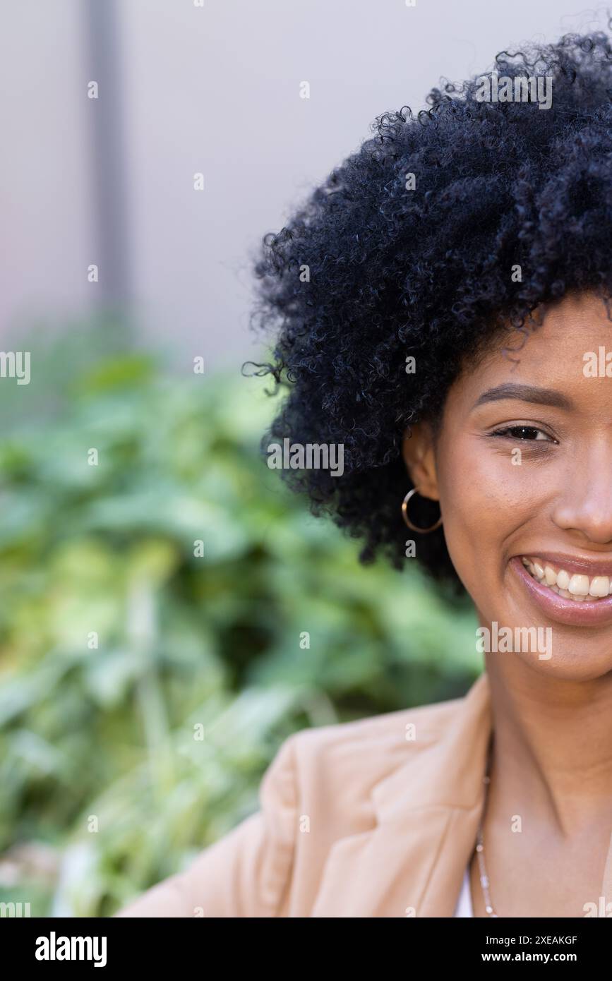 Enjoying break outdoors, smiling woman in casual business attire Stock Photo