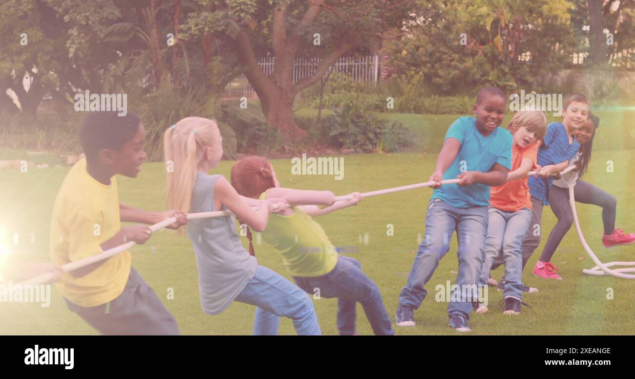 Image of light spots over diverse schoolchildren pulling line in park ...