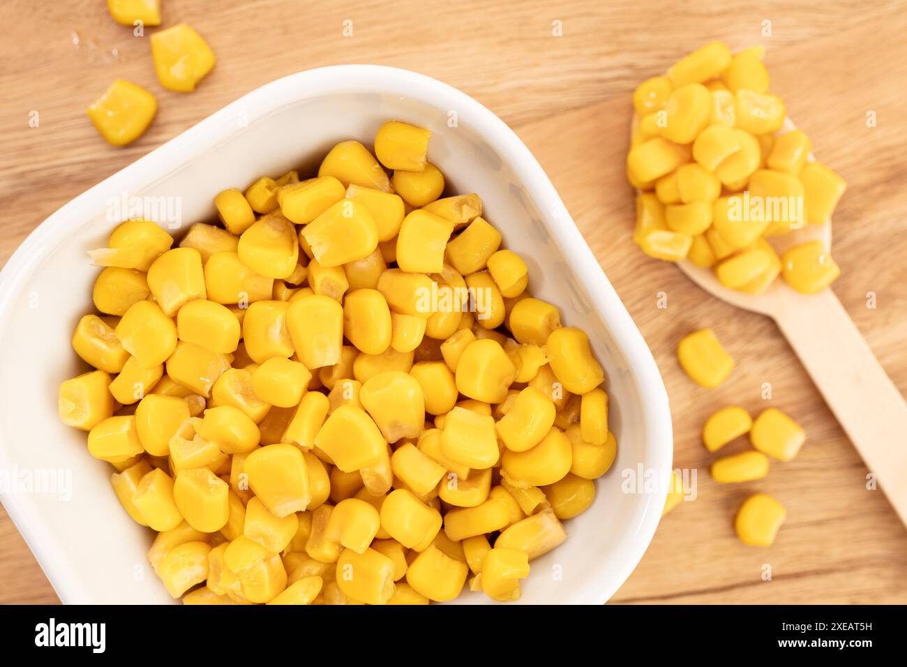 Sweet corn kernels in bowl on wooden table still life Stock Photo