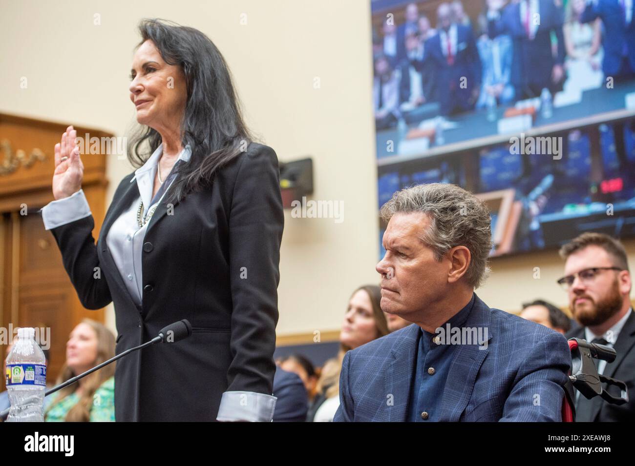 Randy Travis, Recording artist, right, is sworn in with the help of his ...