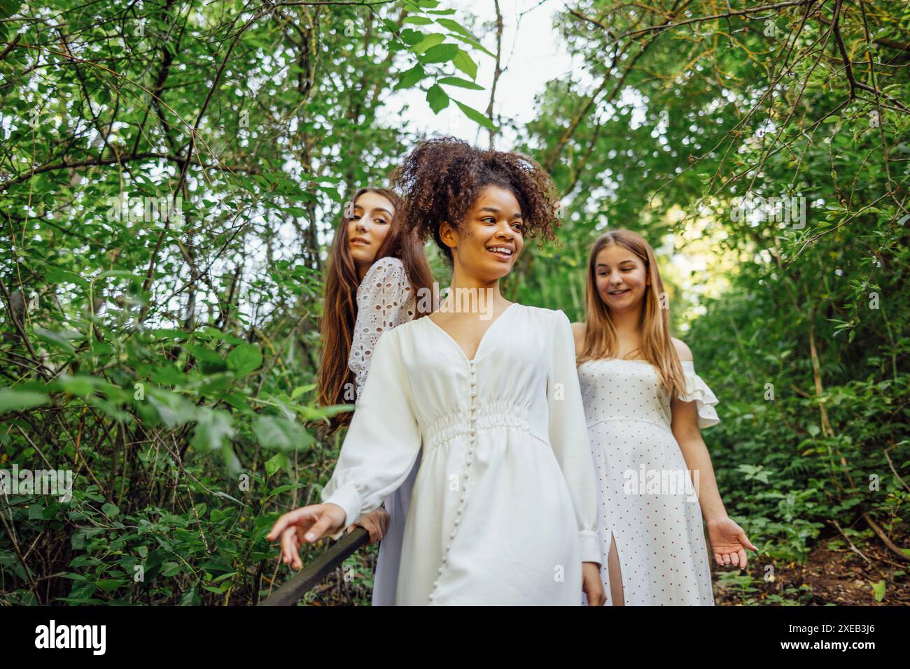 Three happy pretty smiling teenage girls in white summer elegant ...
