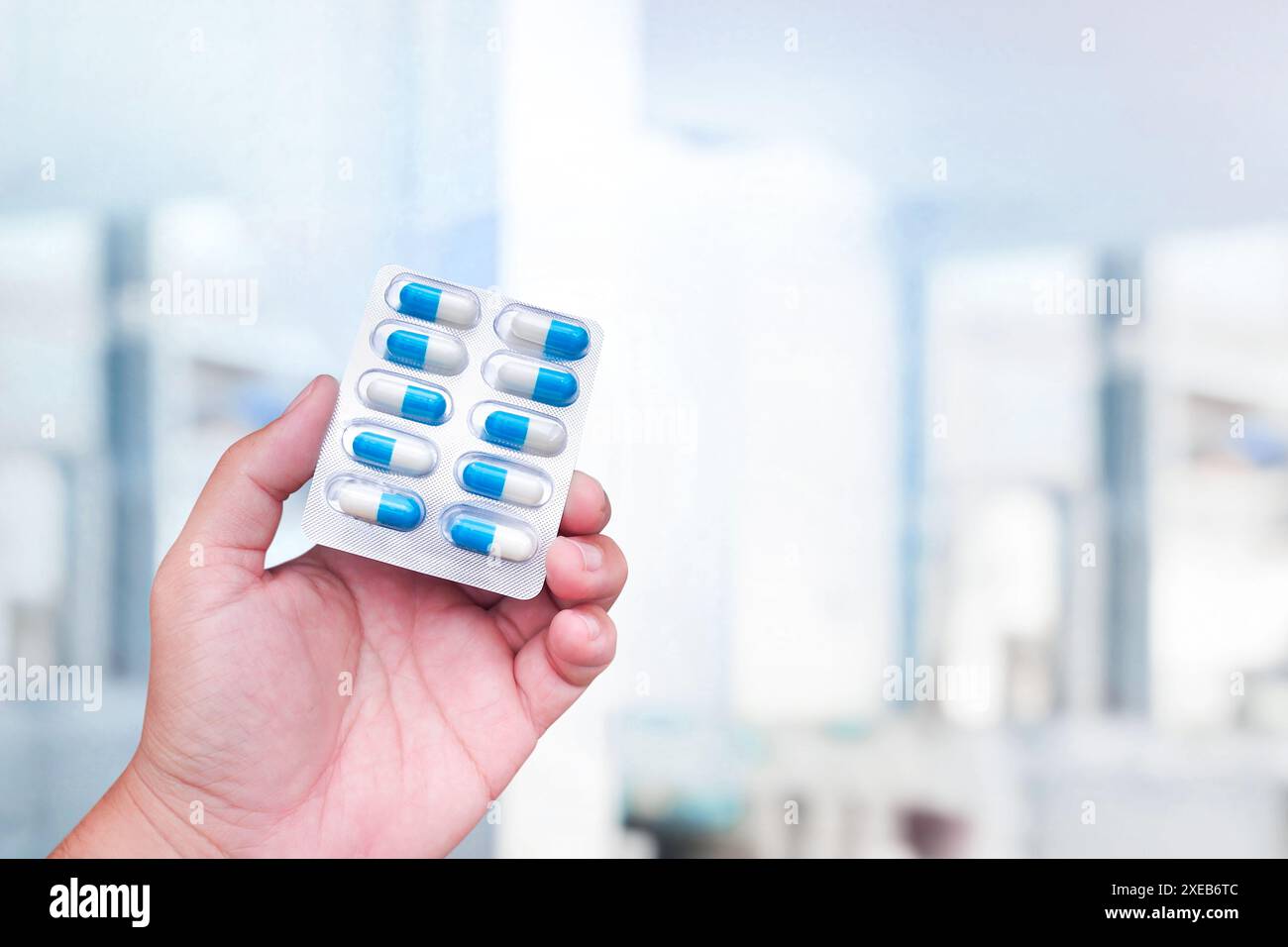 Amoxicillin capsules holding in a human hand , close up of antibiotic capsules pack , Medicine and medical concept Stock Photo