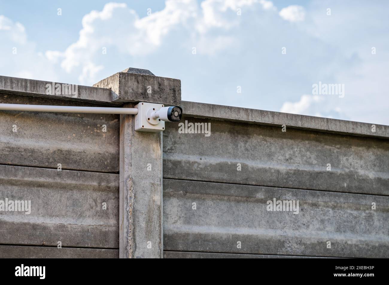 Modern CCTV security camera system install on cement wall with blue sky Stock Photo
