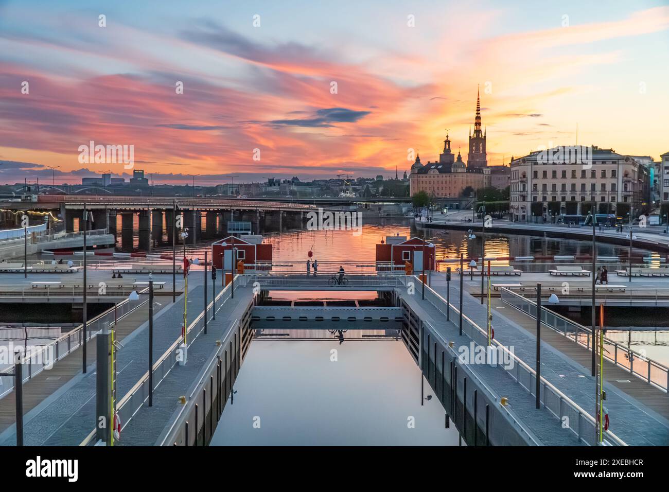 The newly opened Vattentorget, with the canal locks, connection Slussen to Gamla Stan (Old town) Stockholm. Summer evening, orange lights, Stock Photo