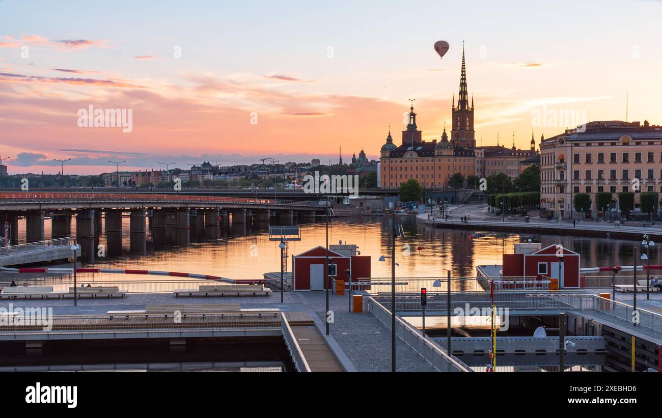 The newly opened Vattentorget, with the canal locks, connection Slussen to Gamla Stan (Old town) Stockholm. Summer evening, orange lights, Stock Photo