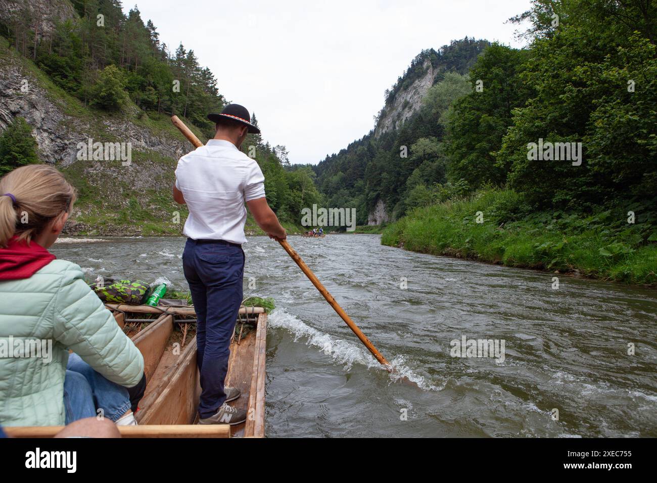 Szczawnica, Poland. 23 July, 2020: A rafting guide skillfully navigates the Dunajec River amidst beautiful mountain terrain. Stock Photo