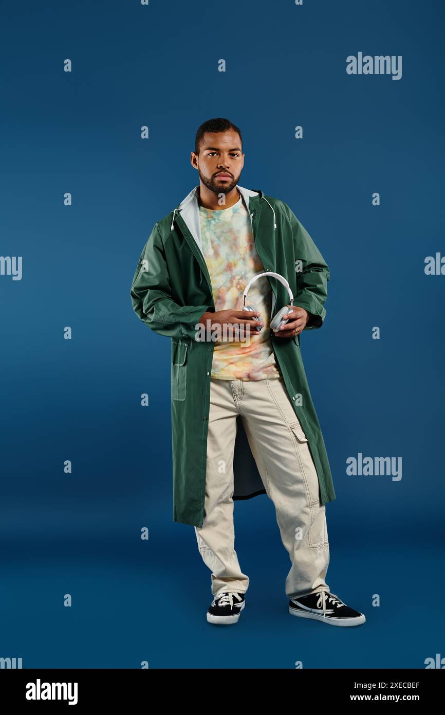 Confident man strikes a pose against a vivid blue background Stock ...