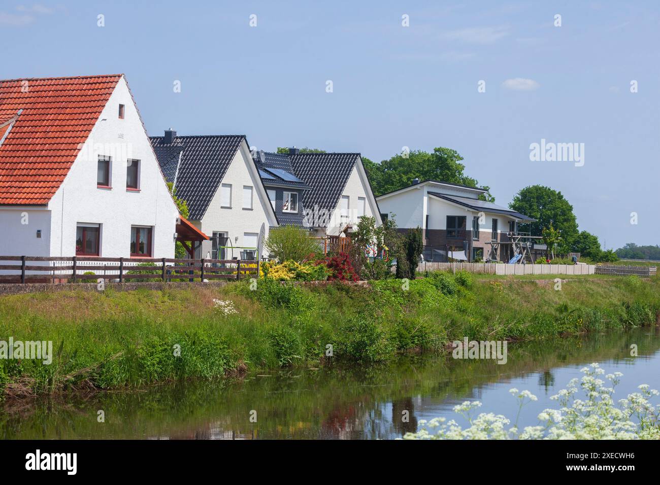 Residential houses, single-family houses, residential buildings, river Goldene Aue, Barenburg, Lower Saxony, Germany Stock Photo