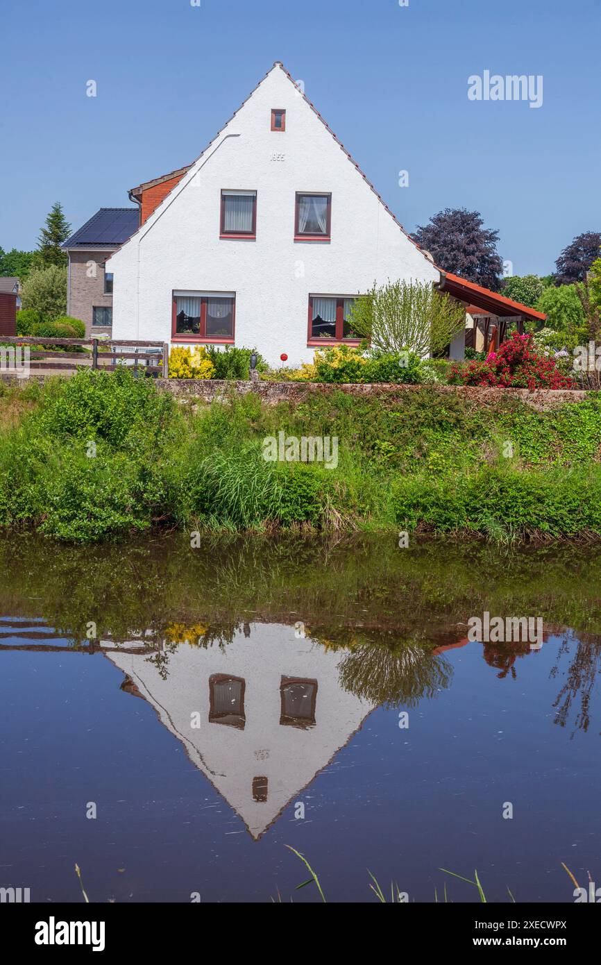 Residential houses, single-family houses, residential buildings, river Goldene Aue, Barenburg, Lower Saxony, Germany Stock Photo
