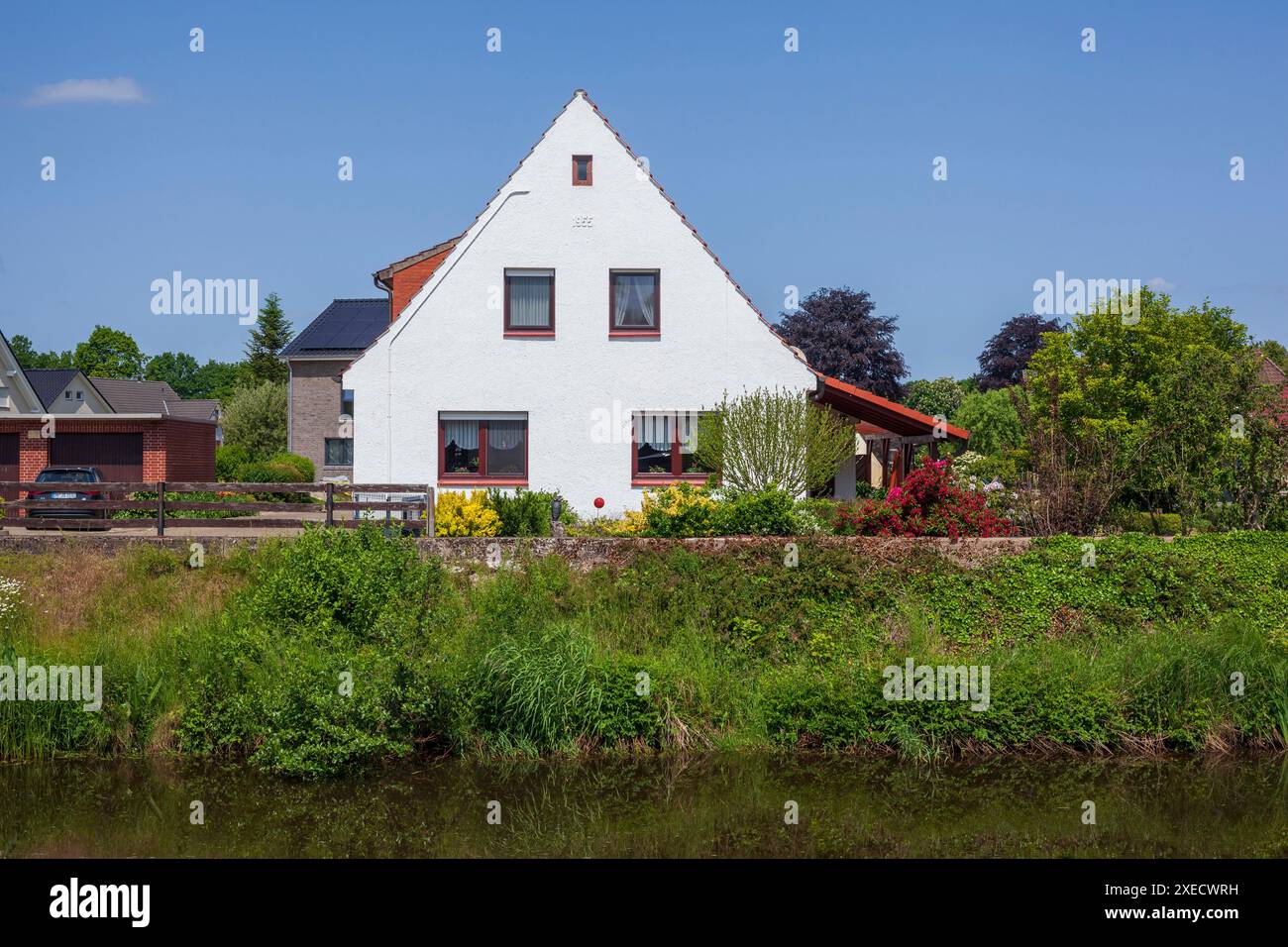 Residential houses, single-family houses, residential buildings, river Goldene Aue, Barenburg, Lower Saxony, Germany Stock Photo