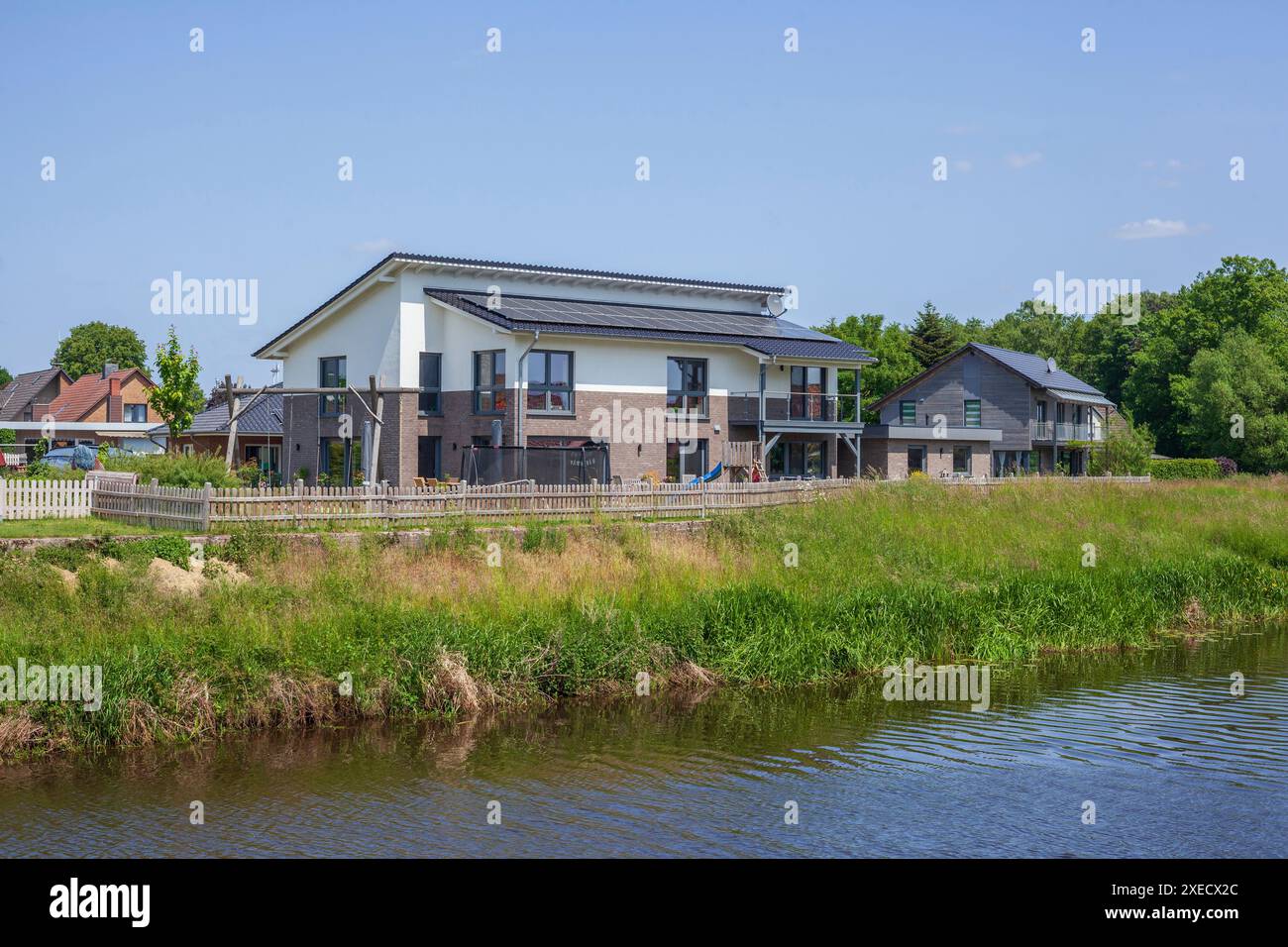 Residential houses, single-family houses, residential buildings, river Goldene Aue, Barenburg, Lower Saxony, Germany Stock Photo