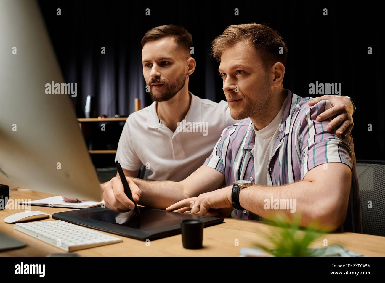 Two Guys Working Focused couple working on project hi-res stock photography and images ...