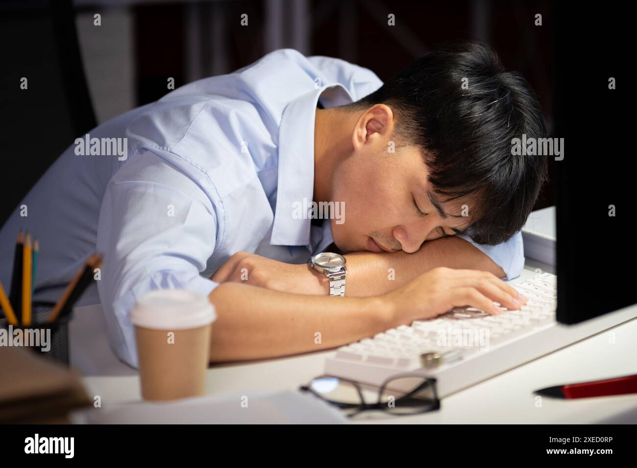 Businessman working overtime at his office He felt tired. Stock Photo