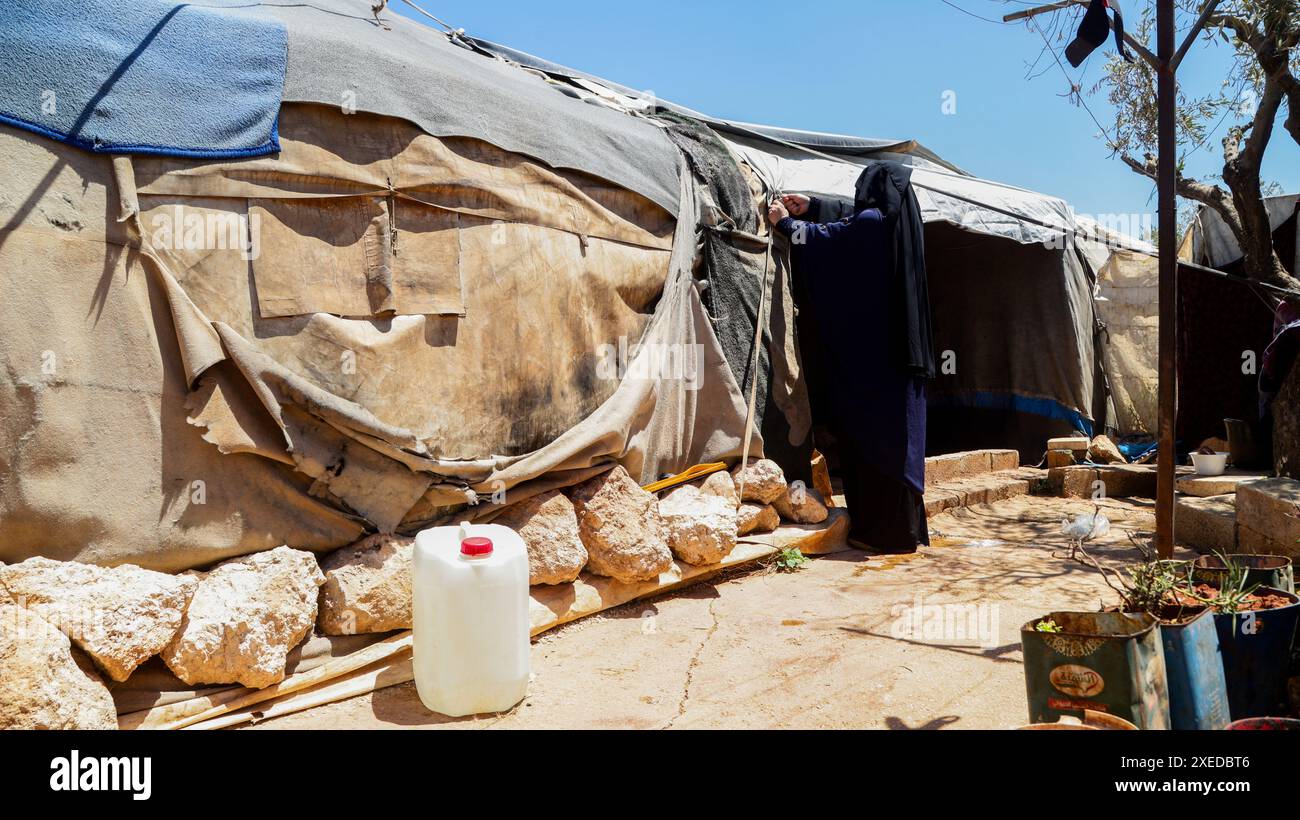 Sarmada, Idlib Governorate, Syria. 11th June, 2024. Sarmada, Idlib, Syria. 11 June 2024. Scenes of daily life in the Tell al-Fakhar camp in northwest Syria. Tell al-Fakhar is one of the internally displaced person (IDP) camps near Sarmada, in the Idlib governorate. Residents of Tell al-Fakhar camp have been living in worn-out tents for 6 years after being displaced from their homes as a result of strikes carried out by the Syrian government forces (Credit Image: © Hussein Ali/IMAGESLIVE via ZUMA Press Wire) EDITORIAL USAGE ONLY! Not for Commercial USAGE! Stock Photo