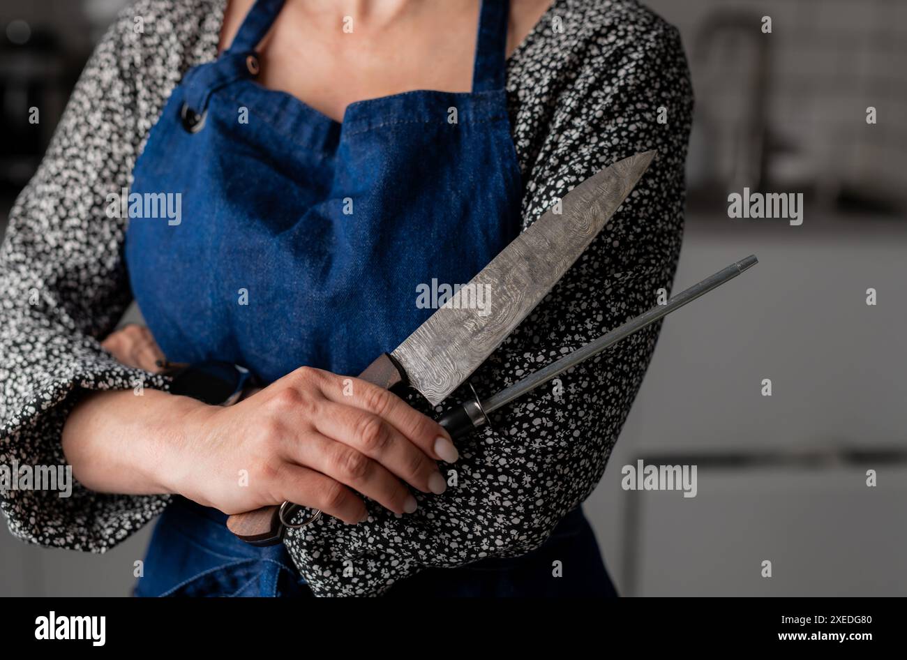 Woman chef holds knife hi-res stock photography and images - Alamy
