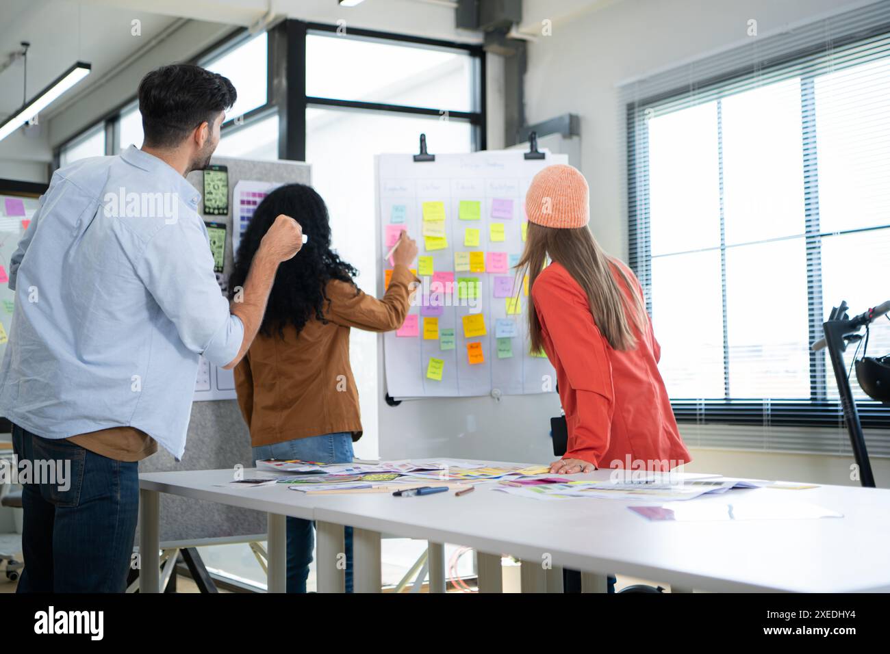 Multiethnic young business people working together in modern office ...
