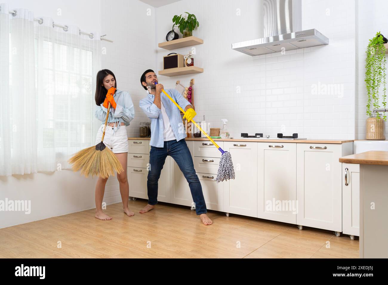 Using Broom Cheerful woman using broom hi-res stock photography and images - Alamy