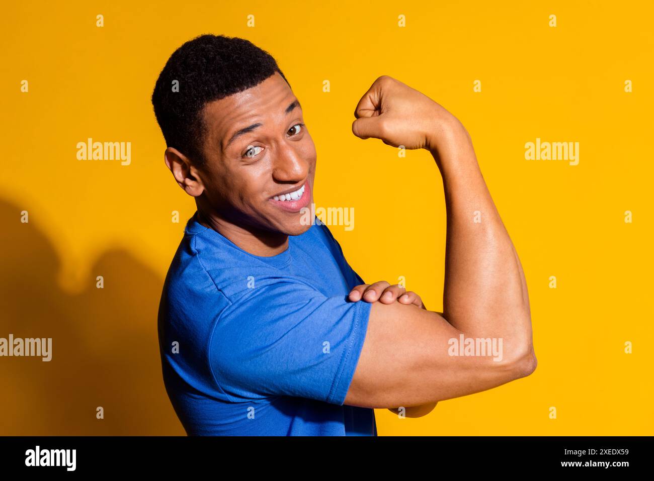 Photo portrait of attractive young man show biceps boast dressed ...