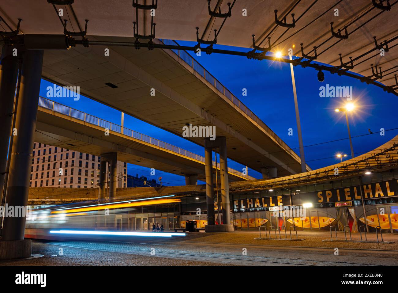 Illuminated Riebeck square traffic junction in Halle in the blue hour with traffic lights Stock Photo