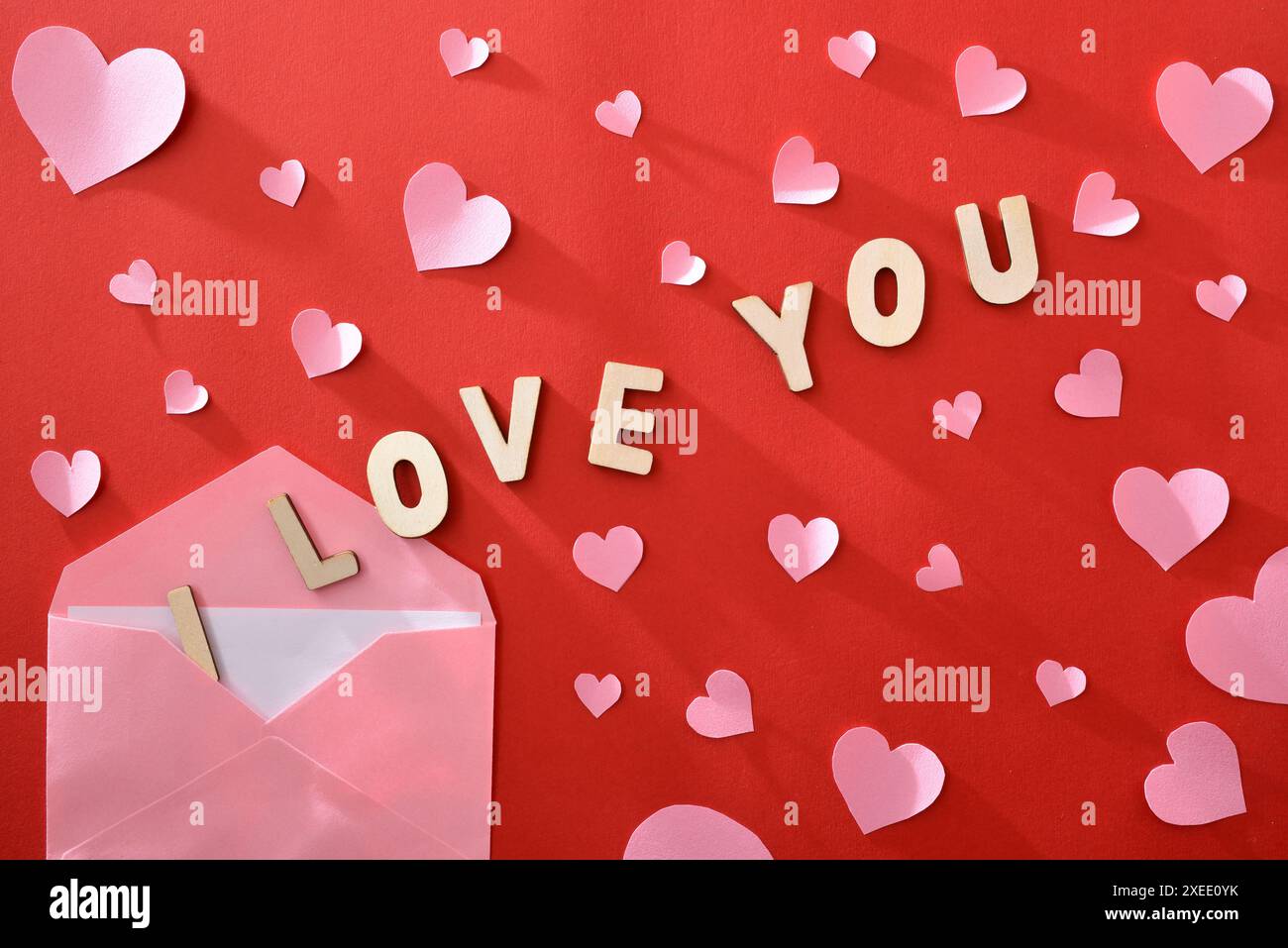 Pink envelope with romantic letter with wooden letters with message I ...