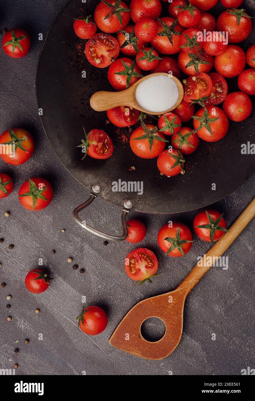 Cherry tomatoes on against black stone surface Stock Photo
