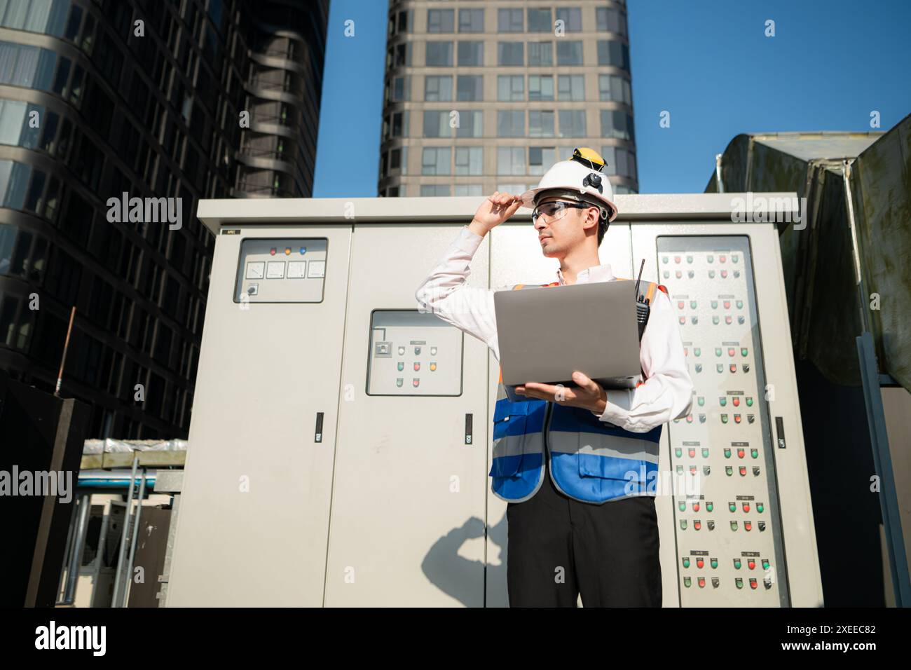 Before proceeding with the testing, Electrical engineer inspects the installed control panel. Stock Photo