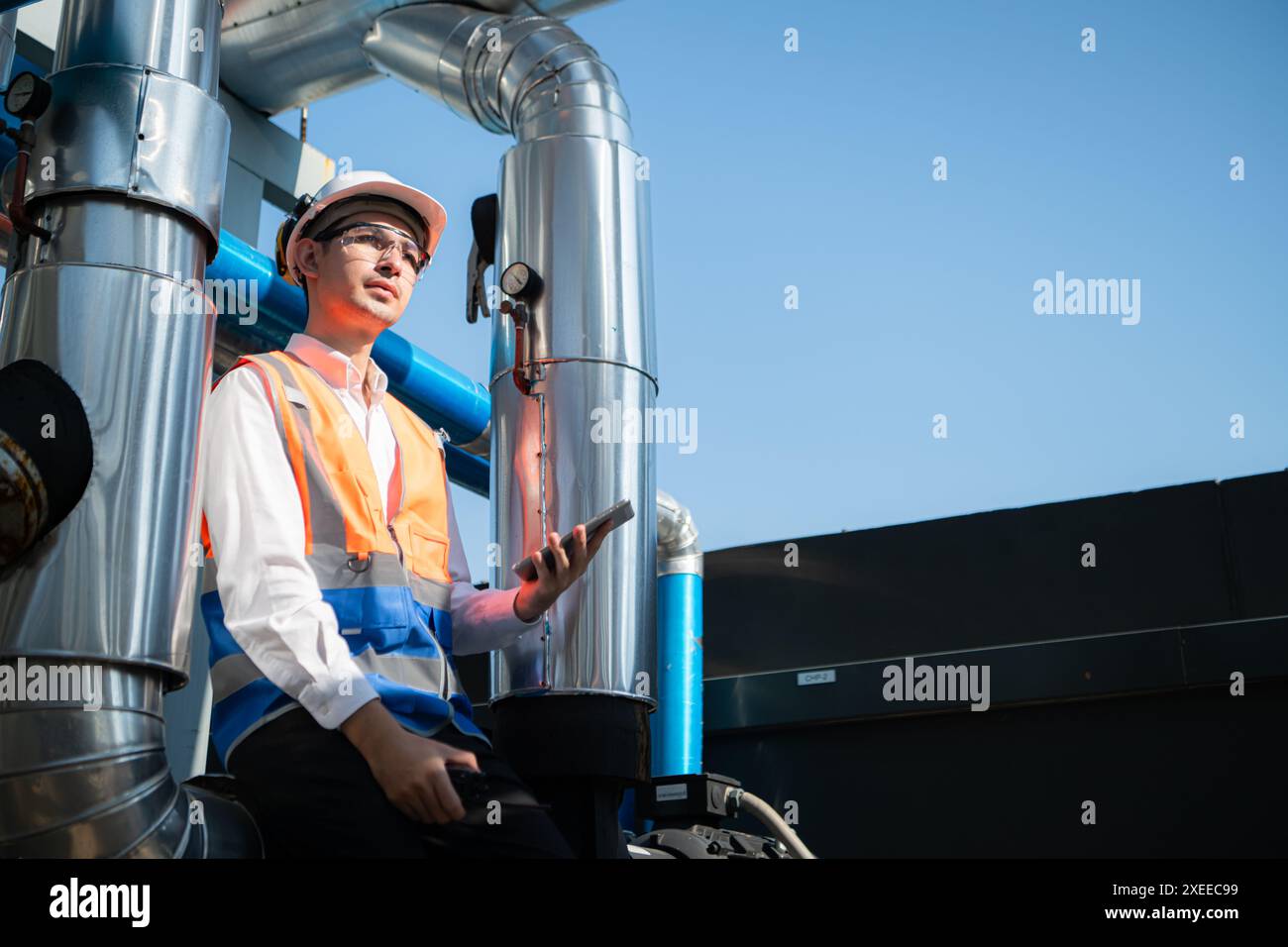 Engineers inspect the completed air conditioning and water systems to continue verifying their functionality. Stock Photo
