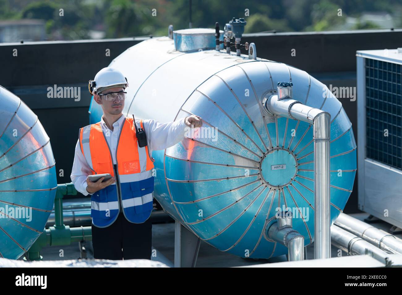Engineers inspect the completed air conditioning and water systems to continue verifying their functionality. Stock Photo