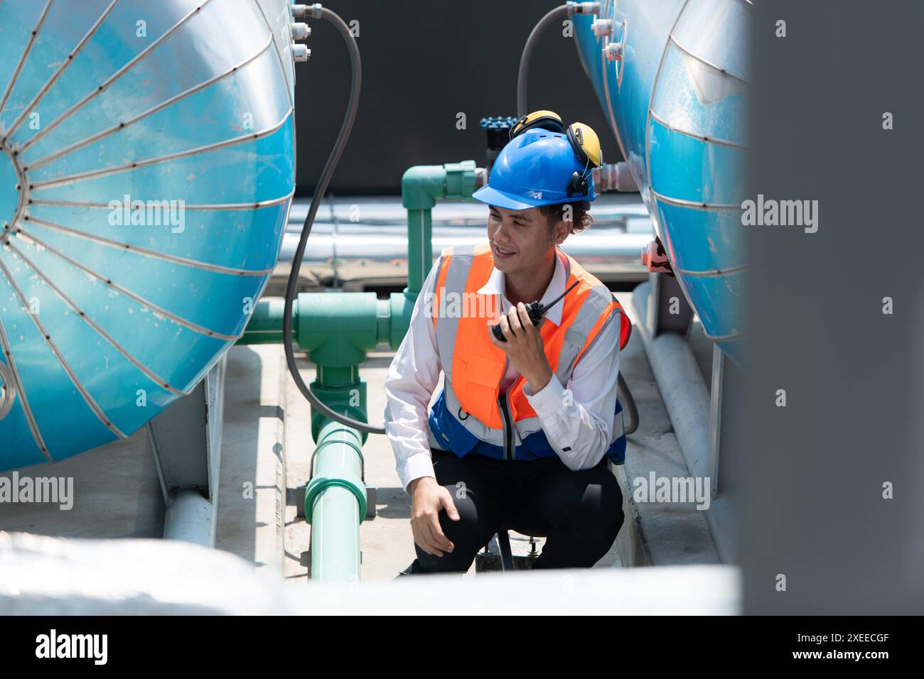 Engineers inspect the completed air conditioning and water systems to continue verifying their functionality. Stock Photo